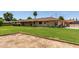 View of the backyard with grass and brick exterior at 1004 E Gemini Dr, Tempe, AZ 85283