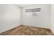 Bedroom featuring carpet flooring and a small window for natural lighting at 1004 E Gemini Dr, Tempe, AZ 85283