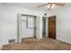 Bedroom featuring carpet flooring, showing the closet and ceiling fan above at 1004 E Gemini Dr, Tempe, AZ 85283
