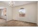 Formal dining room offering a chandelier, arch window and neutral tones at 1004 E Gemini Dr, Tempe, AZ 85283