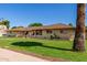 Brick home with mature palm trees, providing shade and a tropical feel at 1004 E Gemini Dr, Tempe, AZ 85283