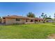 Well-maintained brick home with green lawn and inviting entrance, offering curb appeal at 1004 E Gemini Dr, Tempe, AZ 85283