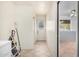 Hallway leading to bonus room, featuring tile flooring and bright white walls at 1004 E Gemini Dr, Tempe, AZ 85283