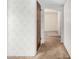 Hallway leading to the living area featuring neutral walls and flooring at 1004 E Gemini Dr, Tempe, AZ 85283