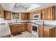 Bright kitchen with light-colored cabinets, white appliances, and tile floors at 1004 E Gemini Dr, Tempe, AZ 85283