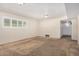 Spacious living room with carpet flooring and a bright window offering natural light at 1004 E Gemini Dr, Tempe, AZ 85283