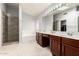 Spacious bathroom featuring double sinks, a soaking tub, and a glass-enclosed shower at 10934 W Almeria Rd, Avondale, AZ 85392