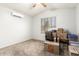Bedroom with an air conditioner, ceiling fan and natural light from the window at 10934 W Almeria Rd, Avondale, AZ 85392