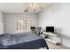 Bedroom with a comfortable bed, ceiling fan, and an abundance of natural light at 10934 W Almeria Rd, Avondale, AZ 85392