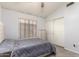 Bedroom featuring plush carpet, natural light, and closet access at 10934 W Almeria Rd, Avondale, AZ 85392