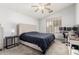Comfortable bedroom with neutral colors, a ceiling fan, and a dedicated workspace at 10934 W Almeria Rd, Avondale, AZ 85392