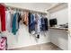 Walk-in closet with ample hanging space and built-in shelving for organization at 10934 W Almeria Rd, Avondale, AZ 85392