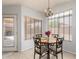 Cozy dining area with chandelier and natural light streaming through the window at 10934 W Almeria Rd, Avondale, AZ 85392