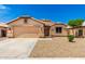 Charming single-story home featuring a two-car garage, neutral stucco exterior, and low maintenance desert landscaping at 10934 W Almeria Rd, Avondale, AZ 85392