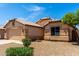 Well-maintained single-story home featuring a two-car garage, desert landscaping, and a mature shade tree at 10934 W Almeria Rd, Avondale, AZ 85392