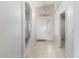 Bright foyer featuring tile flooring, neutral walls, a pendant light, and a white front door at 10934 W Almeria Rd, Avondale, AZ 85392