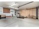 Spacious garage with ample storage cabinets, work space, and exercise equipment at 10934 W Almeria Rd, Avondale, AZ 85392