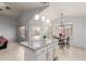 Bright kitchen featuring an island with granite countertops and adjacent breakfast nook at 10934 W Almeria Rd, Avondale, AZ 85392