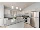 Well-lit kitchen with granite countertops, stainless steel appliances, and modern fixtures at 10934 W Almeria Rd, Avondale, AZ 85392