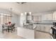 Bright, open kitchen with granite countertops and adjacent dining space, perfect for gatherings at 10934 W Almeria Rd, Avondale, AZ 85392