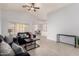 Open-concept living room with vaulted ceilings, neutral walls, tile flooring, and an adjacent dining area at 10934 W Almeria Rd, Avondale, AZ 85392