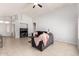 Open living room featuring neutral paint, a ceiling fan, and neutral tile flooring throughout at 10934 W Almeria Rd, Avondale, AZ 85392