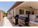 Outdoor grill and smoker on covered back patio at 1166 W Silver Creek Ln, Queen Creek, AZ 85140
