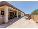 Relaxing back patio with travertine flooring, ceiling fans, built in grill and water feature at 1166 W Silver Creek Ln, Queen Creek, AZ 85140