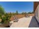 Travertine tiled backyard with plants and seating at 1166 W Silver Creek Ln, Queen Creek, AZ 85140