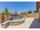 Backyard with travertine tile, water feature, plants, and block wall at 1166 W Silver Creek Ln, Queen Creek, AZ 85140