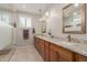 Bathroom showcasing a dual sink vanity with granite countertops and a glass-enclosed shower at 1166 W Silver Creek Ln, Queen Creek, AZ 85140