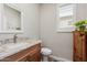 Half bathroom featuring granite countertops, modern fixtures, and great natural light at 1166 W Silver Creek Ln, Queen Creek, AZ 85140