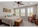 Comfortable bedroom with a ceiling fan and bright natural light streaming through the windows at 1166 W Silver Creek Ln, Queen Creek, AZ 85140