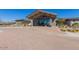 Beautiful clubhouse entrance with a porte cochere and desert landscaping at 1166 W Silver Creek Ln, Queen Creek, AZ 85140