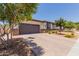 Inviting single-story home with a two-car garage, desert landscaping, and a brick-paved driveway at 1166 W Silver Creek Ln, Queen Creek, AZ 85140