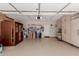 Spacious garage with epoxy flooring, storage cabinets, shelves, and overhead storage at 1166 W Silver Creek Ln, Queen Creek, AZ 85140