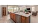 Bright and open kitchen with a large island, stainless steel appliances, and seamless flow to living area at 1166 W Silver Creek Ln, Queen Creek, AZ 85140