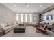 Comfortable lounge area with sectional sofa, armchairs, and stylish décor, creating a relaxing atmosphere at 1166 W Silver Creek Ln, Queen Creek, AZ 85140