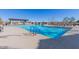 Sparkling community pool with a covered area, seating and plenty of space for lounging at 1166 W Silver Creek Ln, Queen Creek, AZ 85140