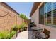 Cozy side yard with Travertine tile and plants at 1166 W Silver Creek Ln, Queen Creek, AZ 85140