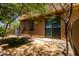 A fenced backyard with a patio, gravel, small patch of grass, and desert landscaping at 1250 S Rialto -- # 78, Mesa, AZ 85209