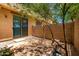 A fenced backyard with a patio, gravel, small patch of grass, and desert landscaping at 1250 S Rialto -- # 78, Mesa, AZ 85209