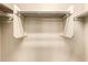 This is an empty white walk-in closet with a hanger rod and shelf for optimal organization at 1250 S Rialto -- # 78, Mesa, AZ 85209