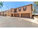 Exterior view of the property with three garage doors and second story balcony at 1250 S Rialto -- # 78, Mesa, AZ 85209
