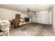A spacious garage with white walls, a gray floor, and a white garage door at 1250 S Rialto -- # 78, Mesa, AZ 85209