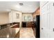 Bright kitchen with granite countertops, black appliances, and convenient breakfast bar at 1250 S Rialto -- # 78, Mesa, AZ 85209