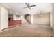 Spacious living area with open layout to kitchen, staircase, ceiling fan, and modern lighting at 1250 S Rialto -- # 78, Mesa, AZ 85209