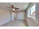 Bright bedroom featuring carpet floors, a ceiling fan, and a closet at 14002 N 38Th St, Phoenix, AZ 85032