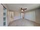 Cozy bedroom with carpeted floors, a ceiling fan, walk in closet and an attached bathroom at 14002 N 38Th St, Phoenix, AZ 85032