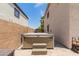 Backyard features a spa for relaxation and a small patio at 14099 W Riviera Dr, Surprise, AZ 85379
